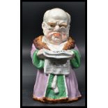 A 19th century Conta & Boehme porcelain tobacco jar & cover of a robed man reading The Times