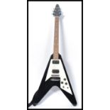 A Jaxville flying V electric guitar musical instrument. Shaped iconic body with chrome tuning