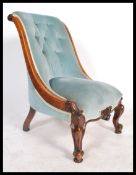 A Victorian mahogany ladies open sided armchair being raised on shaped legs with show wood