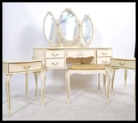 A Louis XV style cream bedroom suite to include a dressing table with a tryptych mirror, bedside