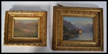 A 20th century continental Italian oil on board painting of a castle and lake scene together with