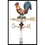 A cast metal weather vane with a cockerel to the top. Measures 73 cm high.