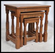 A 20th Century oak nest of three tables, on four octagonal legs united by stretchers. Each nest