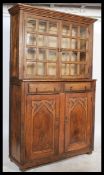 A late 19th early 20th Century Pine farmhouse kitchen cupboard. Two glazed doors with adjustable