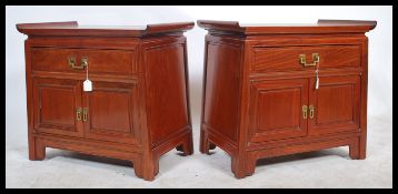A pair of 20th century Chinese elm  wood pedestal bedside / side cabinet tables. Each with alter