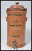 A vintage early 20th century cylindrical Maignen's Filtre Rapide salt glazed wine / water filter,