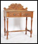 A 19th century Victorian carved honey oak Jacobean revival writing table desk being raised on turned