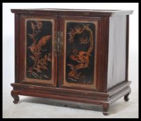 Chinese elm pot cupboard from the Zhejiang Province with carved panel doors and raised on block legs