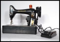 A mid 20th Century vintage based electric Singer sewing machine. The machine painted in typical
