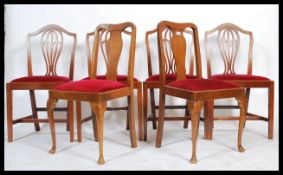 A harlequin set of  dining chairs all upholstered with red velour seats to include a set of 4