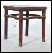 A 20th Century MinGuo period Chinese opium stool in elm wood. The stool table raised on squared legs