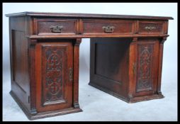 A 19th Century twin pedestal desk having an arrangement of nine drawers with inset leather scribe to
