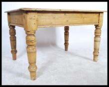 A VIctorian 19th century country pine dining table being raised on turned legs with fitted frieze,