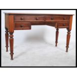 A 19th century Victorian mahogany writing desk raised on turned column legs with two long over two