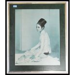A mid century retro mounted print of a Malaysian girl in robes being signed by the artist with