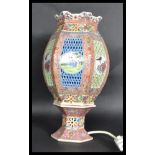 An early 20th century ceramic table lamp of lanter