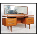 A 1970's G-Plan teak wood dressing table in the manner of Mogens Kolo. The dressing table raised