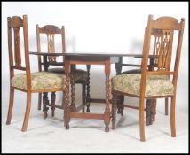 A 1920's oak drop leaf gate leg dining table being