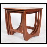 A 1970's retro teak wood Danish influence coffee table of lozenge shaped form raised on atomic /