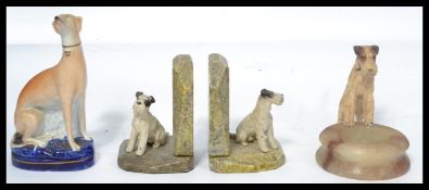 A pair of early 20th Century Art Deco alabaster bookends mounted with cold painted spelter figures