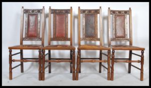 A set of four early 20th Century Arts and Crafts oak dining chairs. Ox blood leather studded seat