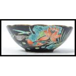 A 19th century Chinese hand painted bowl decorated with vibrant flowers and Asian Teal birds on a