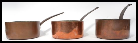 A group of three 19th century copper sauce pans / saucepans having riveted brass handles. Measures