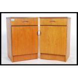 A pair of retro 1970's Danish influenced teak wood bedside cabinets chests. Each with locker door