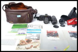 A vintage 20th Century Canon T70 35mm camera and lenses to include FD 50mm, FD 70 - 210mm, FD 35 -