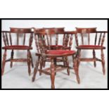 A set of four contemporary  smokers / captains chairs with carved top rails and spindle backs,