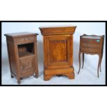 A 19th century solid oak French bedside cabinet with carved door and open recess together with