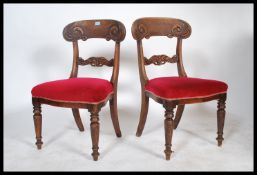 A set of 2 19th century Regency mahogany bar bank dining chairs being raised on turned legs with