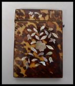 A 19th century Victorian tortoiseshell card case of rectangular form, side hinged button release