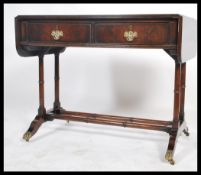 A 19th century Georgian side / writing table raised on turned legs having a double drop leaf end