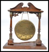 A Victorian 19th century oak and brass table gong. oak frame with polished brass bracket work,