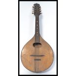 A vintage 20th Century eight string acoustic mandolin, mother of pearl inlays to the fretboard /