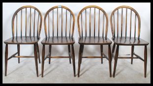 A set of four 20th Century hoop back dining chairs by Ercol, constructed from beech and elm and