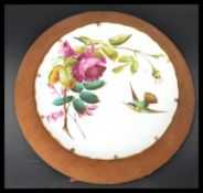 A 19th century cabinet plate painted in relief depicting a humming bird and flowers set to a Gypsy