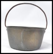 A 19th century Victorian bronze preserve pan of typical form with shaped iron handle atop.