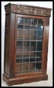 A 19th /. 20th century oak bookshelf cabinet having a carved top with lead lined drawers. Complete