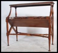 A Regency style carved mahogany two tier book trough with open fretwork and raised on turned