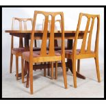 A 1970's Danish influence teak wood dining room suite to include extending dining table and chairs