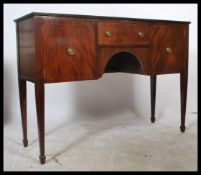 A 19th century mahogany sideboard being raised on square tapering legs with a series of drawers