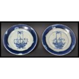 A pair of 18th century Chinese blue and white hand painted plates having blue borders with central