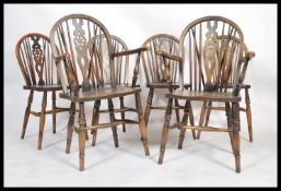 A set of six beech and elm wheel and spindle stick back Windsor dining chairs. Set comprising of two