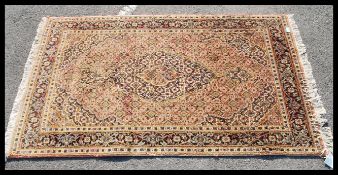 An early 20th Century Iranian floor rug on beige ground with central panel and geometric borders.