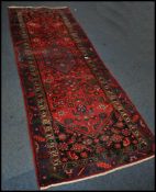 A 20th century Kelim woollen rug / runner , on red