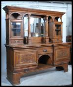 A 19th century large Arts & Crafts mirror back sideboard. Raised on tall stile legs with a series of
