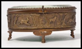 A 19th century bronze Victorian small jewellery box having an open beveled glass panel lid with