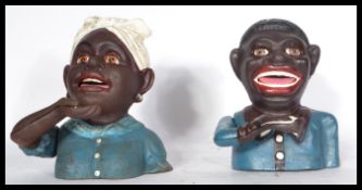 A pair of cast metal negro money banks depicting jolly boy banks and and washer women.